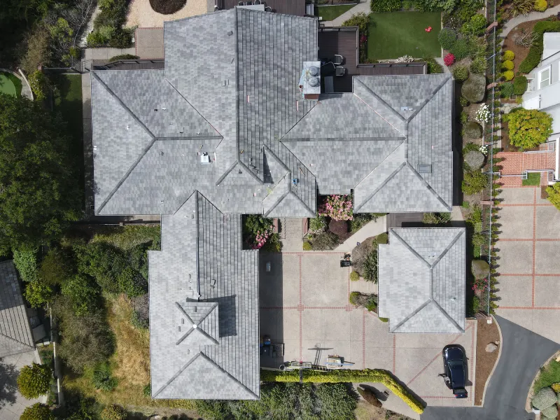 Tile Roof Replacement Project ariel view big house black car