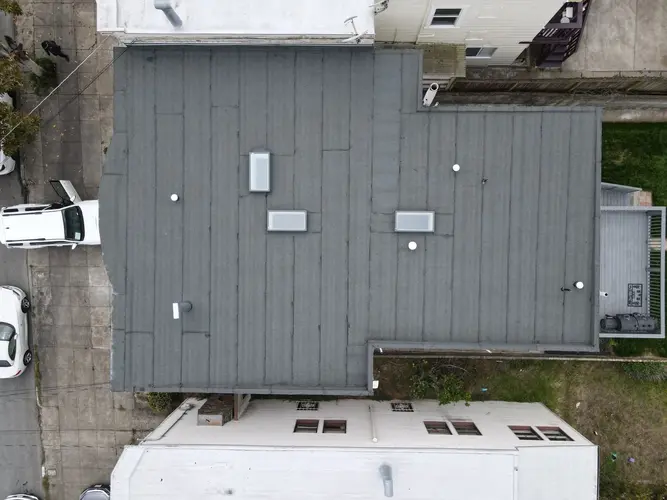 Flat roof installation with skylights and vents in coastal Santa Cruz