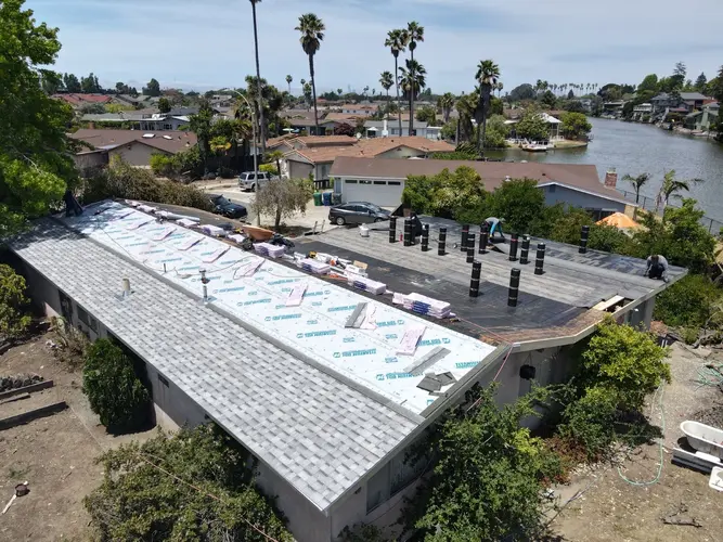 Residential roofing project by Apollo Roofing Company in Santa Cruz, showing new shingles and underlayment