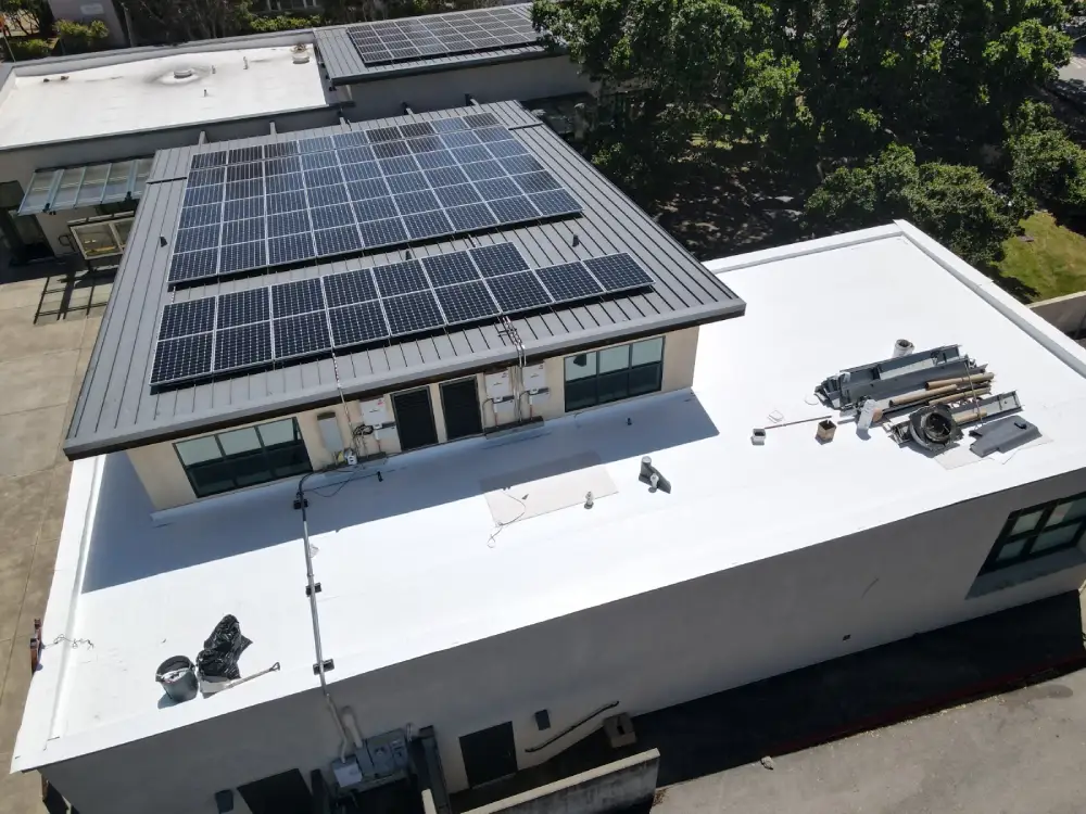 Contractors installing TPO roofing membrane on Sacramento property