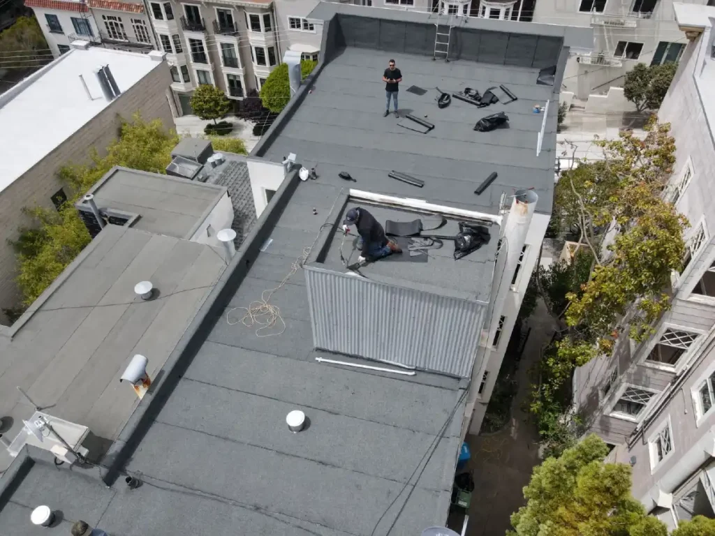 Roofing professionals installing torch down roof system in Novato