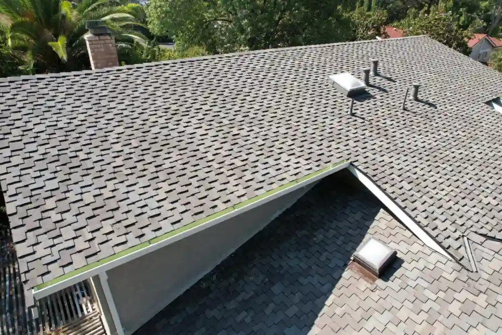 Residential roof with gray shingles photographed from above