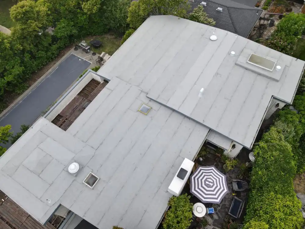 Modified bitumen roofing crew inspecting a flat roof in San Rafael