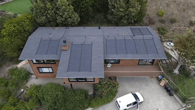 Red house white car front view solar roof