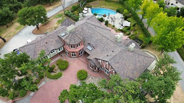 big red house with swiming pool trees
