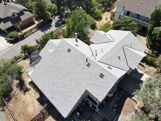 gray roof big house centre trees road