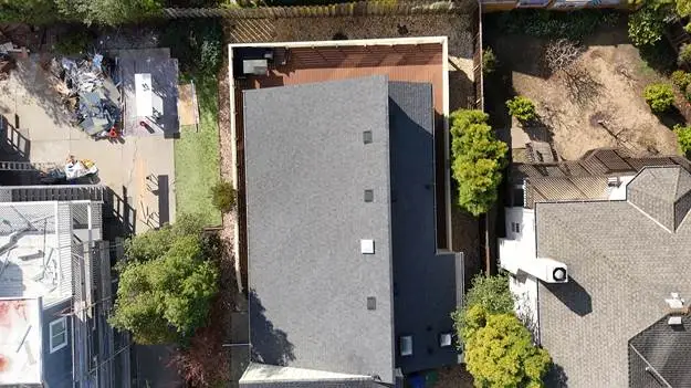 black roof house trees
