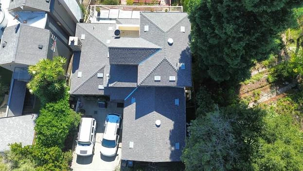 gray roof house with 2 cars